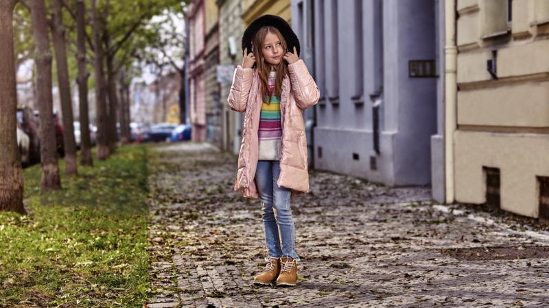 Dívka v Praze chodící v ulici oblečená v NAX kabátku.